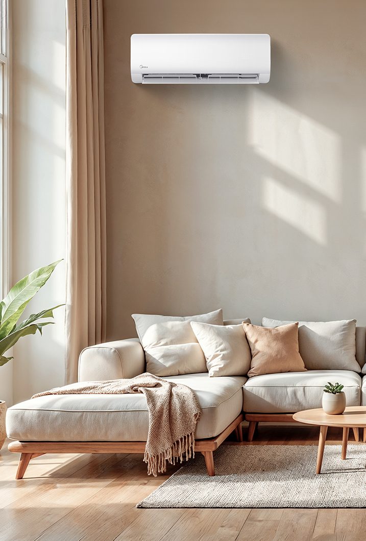 Midea wall-mounted mini-split above a sofa in a sunlit living room